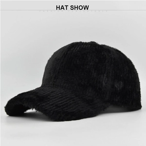 Close-up of black plush baseball cap with vertical knit texture and warm faux fur finish