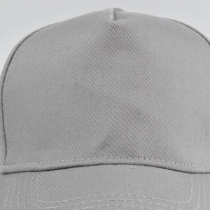 Close-up detail of grey cotton twill fabric texture and stitching on a baseball cap