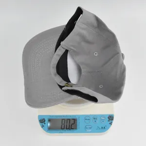 Detailed view of grey cotton baseball cap weight showing 80.2g on a digital scale