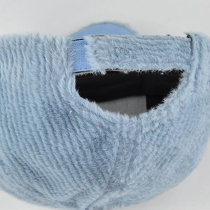 Macro view of light blue faux fur baseball cap showing plush texture and back closure detail