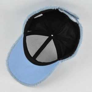 Inside view of light blue faux fur baseball cap with black lining and adjustable strap