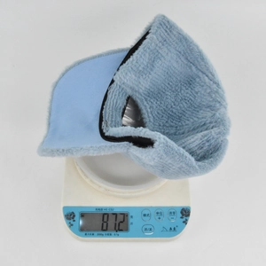 Detail view of light blue thermal ear flap hat weighing approximately 87.2 grams
