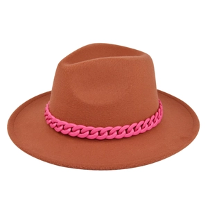 Detailed macro view of the brown wide-brim wool hat featuring a vibrant pink chain accessory