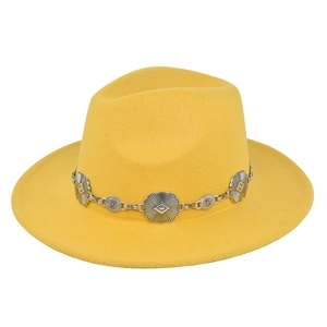 Detail of lemon yellow fedora hat with a decorative silver floral metal chain accessory
