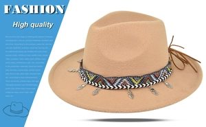 Detail of camel wool fedora hat featuring geometric ethnic band and metal leaf charms