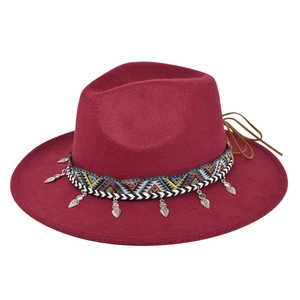 Detail of wine red wool fedora hat featuring ethnic geometric band and silver heart charm