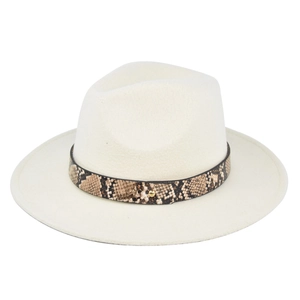 Detail of cream fedora hat featuring a snake-pattern leather band and gold metal stud