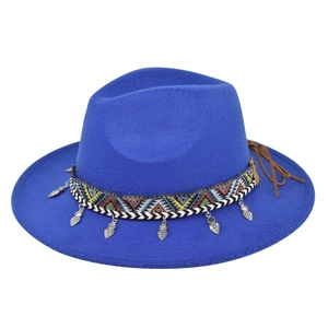Detail of royal blue wool felt fedora with ethnic woven band and heart metal charms