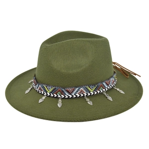 Detail of army green fedora with ethnic embroidery band and silver heart pendants