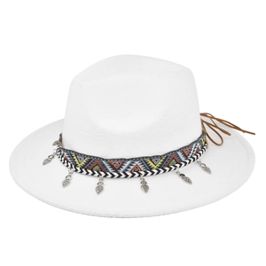 Detail of white felt fedora hat featuring ethnic woven band and silver leaf pendants