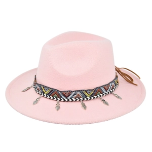 Detail view of pink fedora featuring bohemian embroidery and heart metal pendants