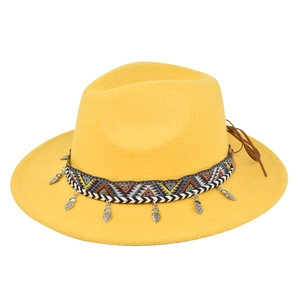Detail of yellow wool fedora hat with ethnic patterned band and silver heart charms