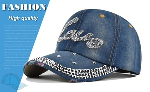 Detailed view of blue denim baseball cap featuring sparkly Love rhinestone lettering