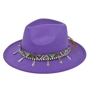 Detail of purple wool felt fedora with ethnic ribbon and silver heart charms
