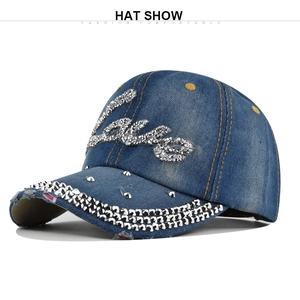 Detail of blue denim baseball cap featuring Love rhinestone letters and metal studs