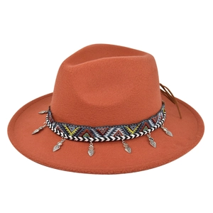 Detail of bohemian felt fedora with ethnic woven band and silver heart charms