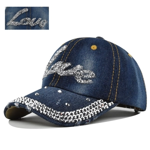 Close-up of sparkling rhinestone Love lettering and crystal details on denim baseball cap