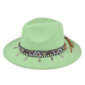 Detail of mint green wool fedora featuring ethnic woven band and silver metal charms