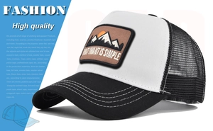 Detailed view of the mountain embroidery patch and contrast stitching on a trucker hat