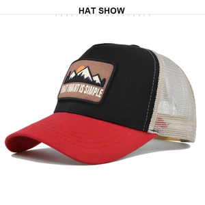Detail of truck hat with mountain embroidery and breathable cream mesh back