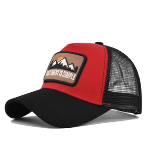 Detail view of red and black trucker hat featuring mountain sunrise embroidery patch