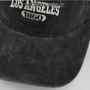 Close-up of Los Angeles white embroidery on washed vintage black baseball cap texture