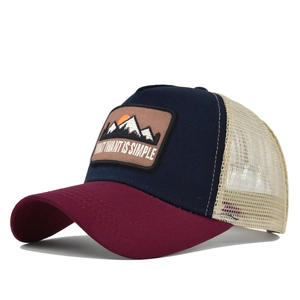 Detailed close-up of mountain embroidery and mesh back on the vintage trucker hat