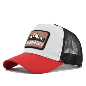 Detail view of the mountain patch and red stitching on this mesh trucker baseball hat