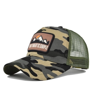 Detail of woodland camouflage trucker hat with embroidered mountain patch and green mesh back