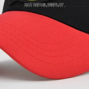 Close-up of baseball cap featuring curved reinforced stitching on red cotton visor