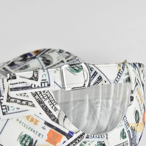 Detail view of adjustable metal buckle and dollar bill print on baseball cap back