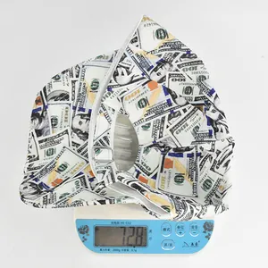 Detailed top view of a white dollar pattern bucket hat on a scale weighing 72.8g