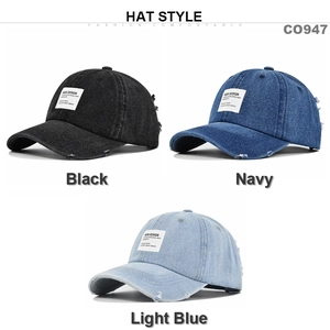 Detail view of vintage distressed denim baseball caps with embroidered NEW DESIGN patches