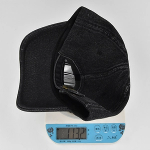 Detail showing the adjustable metal buckle and light weight of this vintage denim cap