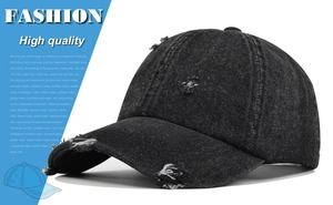 Detailed view of distressed black denim baseball cap with vintage frayed hole accents