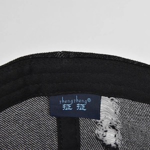 Detailed close-up showing the inner brand label and twill fabric texture of denim baseball cap