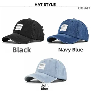 Detailed view of distressed denim baseball caps in black, navy, and light blue wash