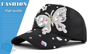 Close-up of black baseball cap with rhinestone butterfly and floral crystal ornaments