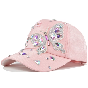 Detailed close-up of pink sparkling baseball cap with crystal butterfly and rhinestones