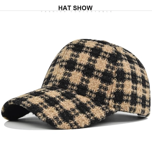 Close-up of yellow and black plaid tweed baseball cap showing premium woven texture