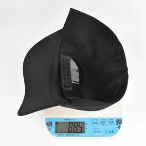Detailed view showing the black baseball cap weighing 88.5 grams on a digital scale