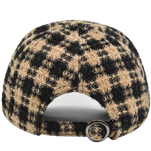 Detail view of houndstooth baseball cap with adjustable metal buckle at the back