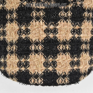 Detailed macro shot of textured tweed fabric pattern on a plaid baseball cap