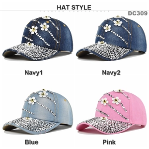 Detail of four denim baseball caps with floral patterns and sparkling rhinestones