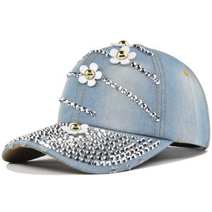 Detail of light blue denim baseball cap with silver rhinestones and white floral accents