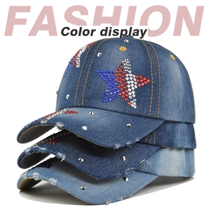 Detail of distressed denim baseball caps with rhinestone star patches in multiple washes