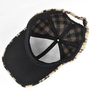 Internal detail of plaid baseball cap showing inner lining and metal adjustable buckle