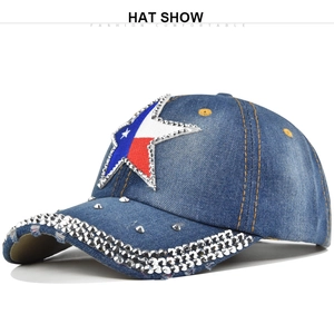 Detail of Texas flag star patch with silver studs on distressed navy denim baseball cap