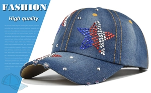 Detail of vintage blue denim baseball cap with rhinestone stars and silver studs