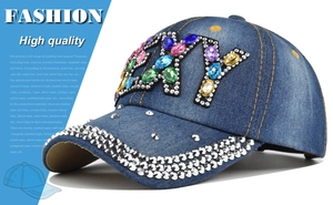 Close-up of sparkling colorful rhinestones and NY logo on a denim baseball cap